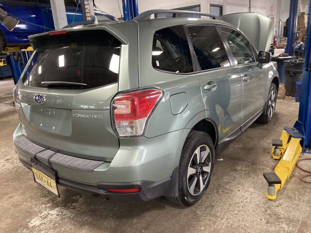 Vehicle raised on lift for undercarriage inspection